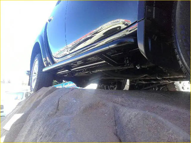 Black chrome finished steel rockarmor rockslider side steps on dark blue mitsubishi triton ml/mn underbody guard