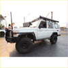 White toyota land cruiser 70 with black steel rockarmor rockslider side steps perfect for offroad 4wd ute use