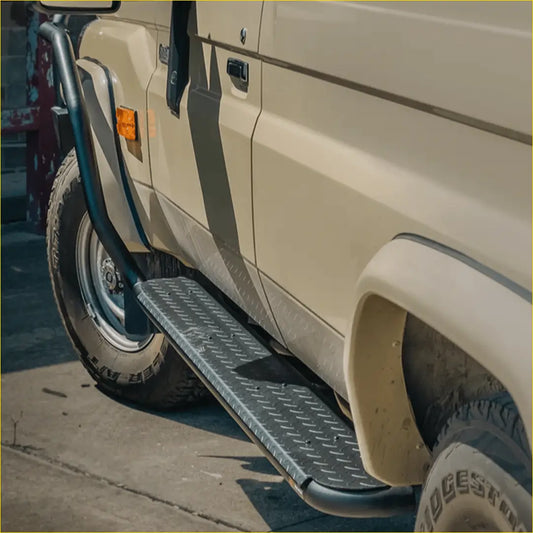 Black diamond plate steel rockarmor rockslider side step mounted on beige toyota landcruiser 78 side