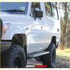White toyota land cruiser with black rockarmor steel rockslider side steps and rugged offroad tires for 4wd use