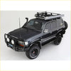 Black toyota land cruiser with rockarmor steel rockslider side steps and rugged offroad tires for 4wd use