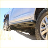 Black steel rockarmor rockslider side step bar mounted on lower edge of silver 4wd ute for offroad use