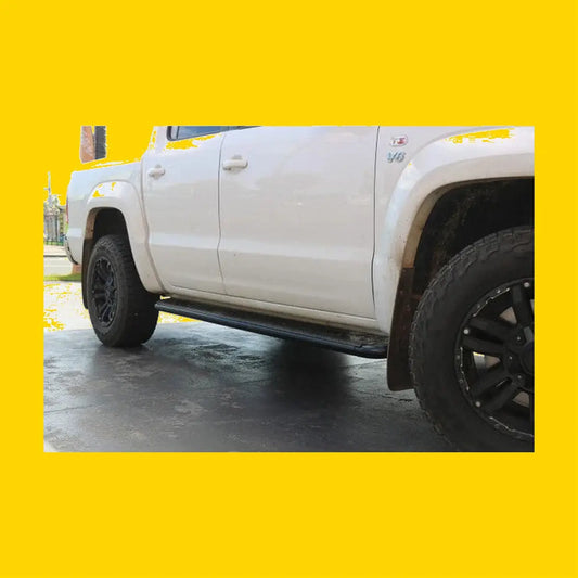 Black metal rockarmor steel rockslider side step on the back side of a white vw amorok pickup truck
