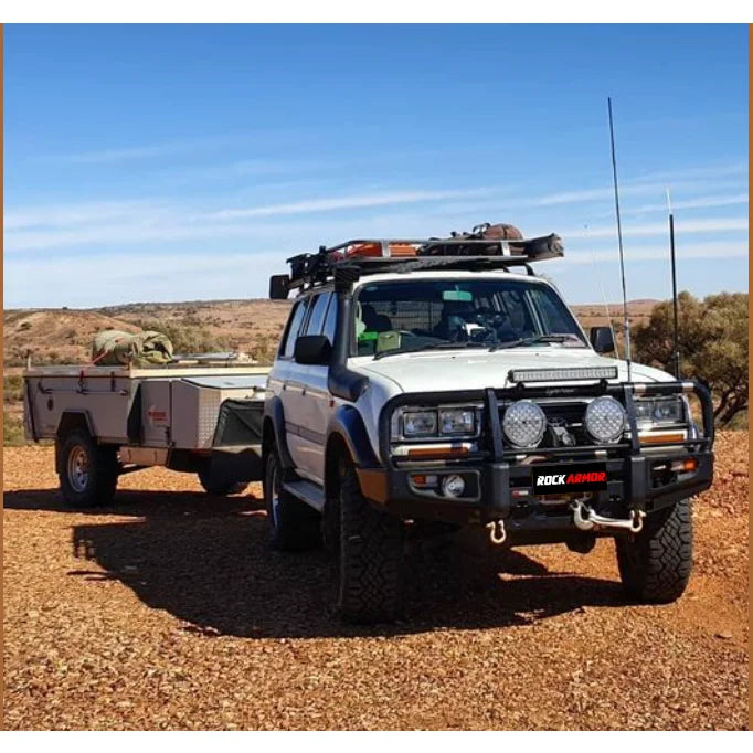 White off-road vehicle towing trailer with Rockarmr steel bullbar and fog lights