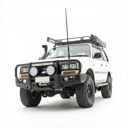 White toyota land cruiser with black steel rockarmr premium bullbar and roof rack for off-road use