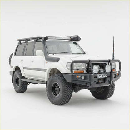 White toyota land cruiser 100 with black rockarmr premium steel bullbar and rugged off-road tires