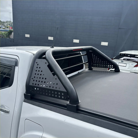 Black perforated metal roll bar with curved bars and side panels for toyota hilux 2021-2025 truck bed rail back view