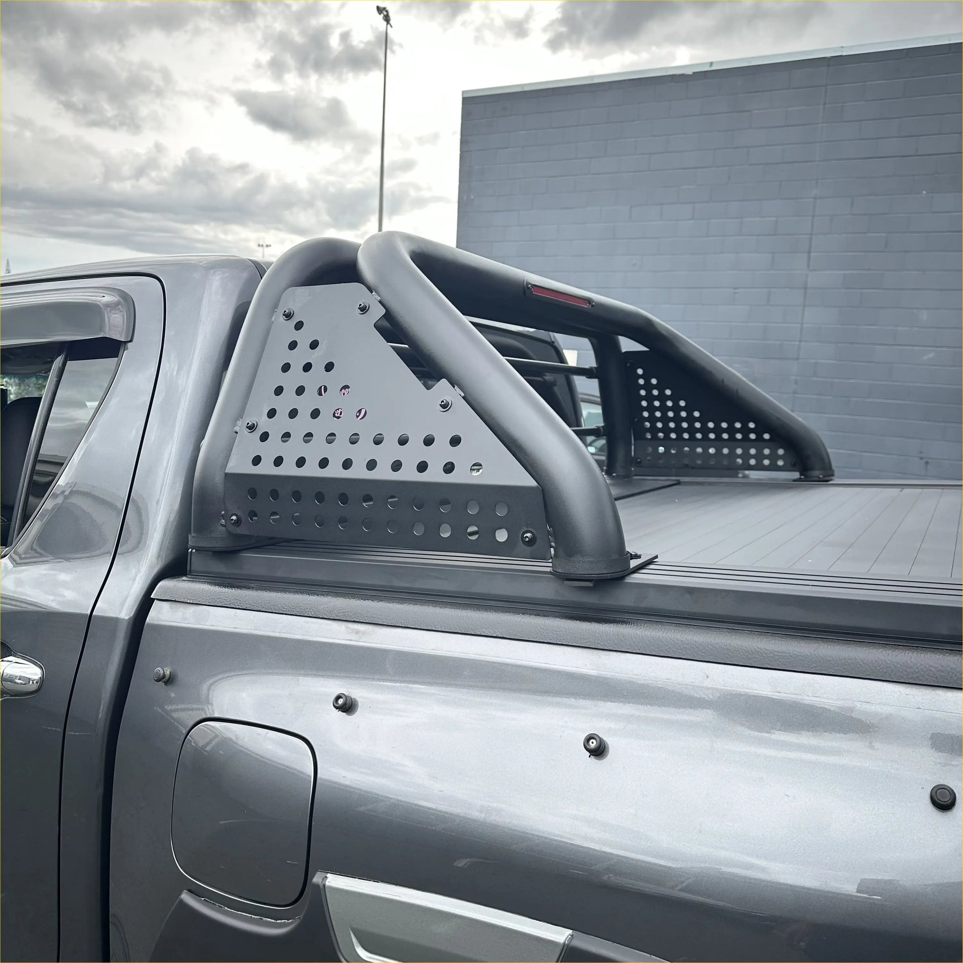 Black perforated metal truck bed rail with curved tubular design shown from back for ford ranger 2022+ roll bar t10