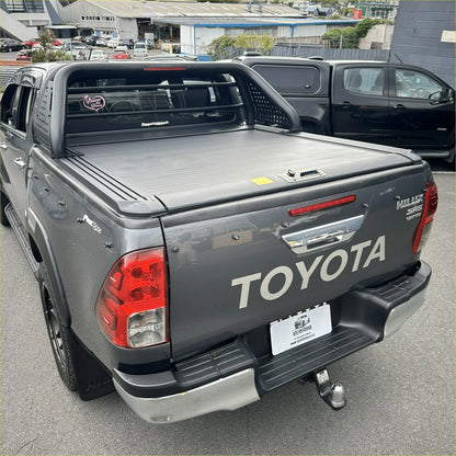 Back view of gray toyota hilux sr5 with black manual roller shutter and chrome roll bar t10 accessories