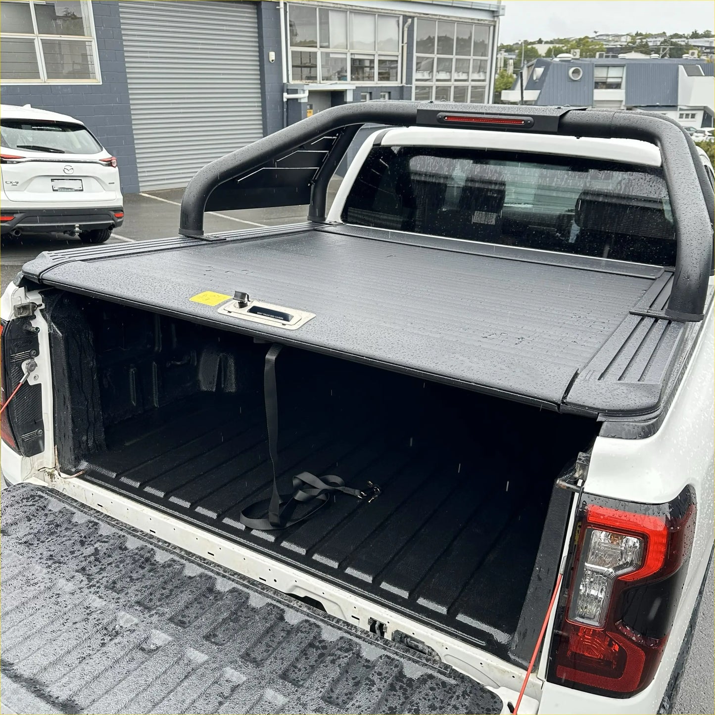 Black textured roll bar T20 tonneau cover with integrated handle and lock for Ford Ranger 2022 plus shown from back side