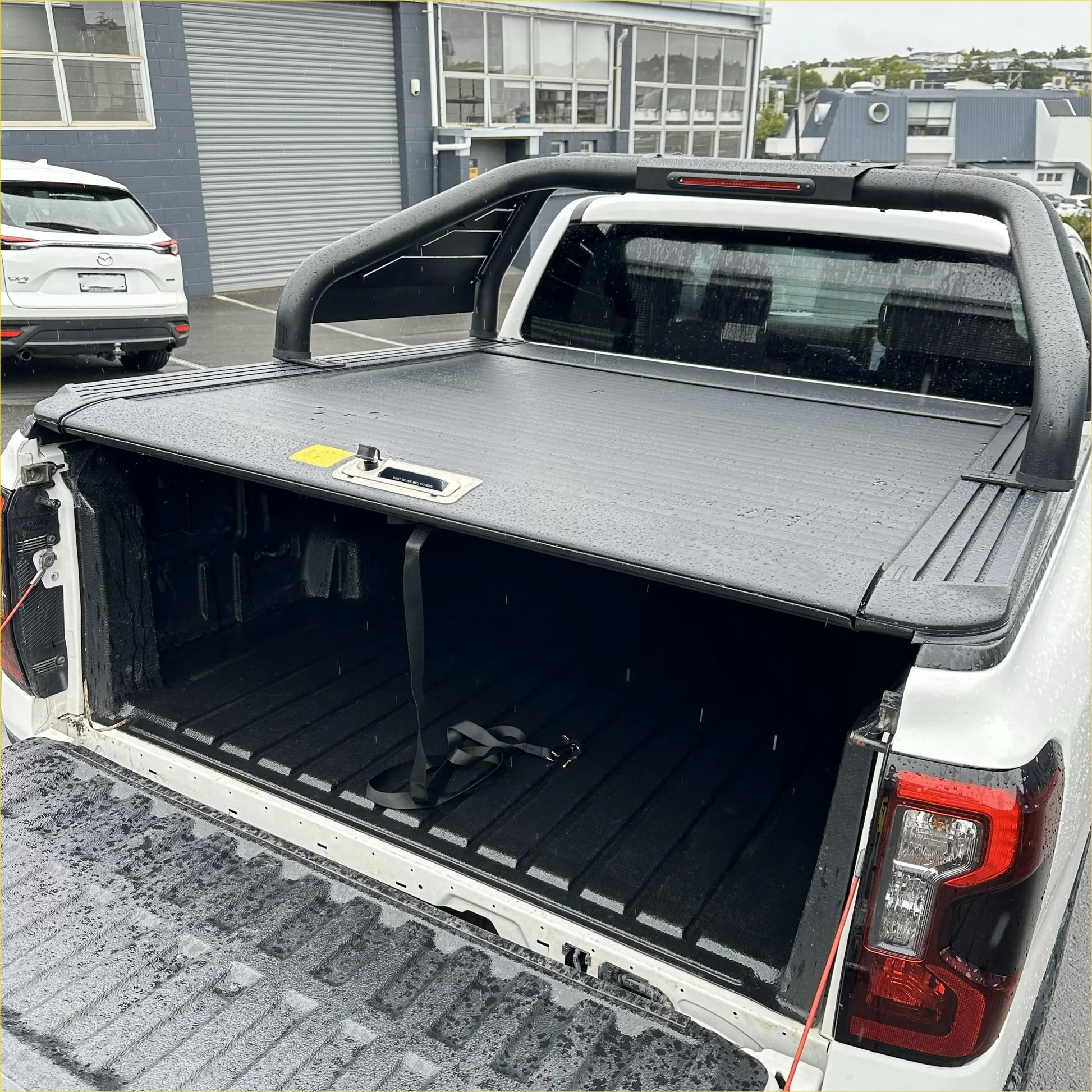 Black textured roll bar T20 tonneau cover with integrated handle and lock for Ford Ranger 2022 plus shown from back side