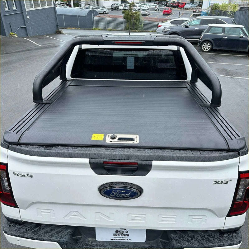 Black durable roll-up tonneau cover with sleek ribbed texture and handle for ford ranger xlt 2022+ back view
