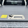 Backside of gray textured roll bar t20 truck bed cover with metallic handle and black best truck bed covers label for ford ranger 2022+