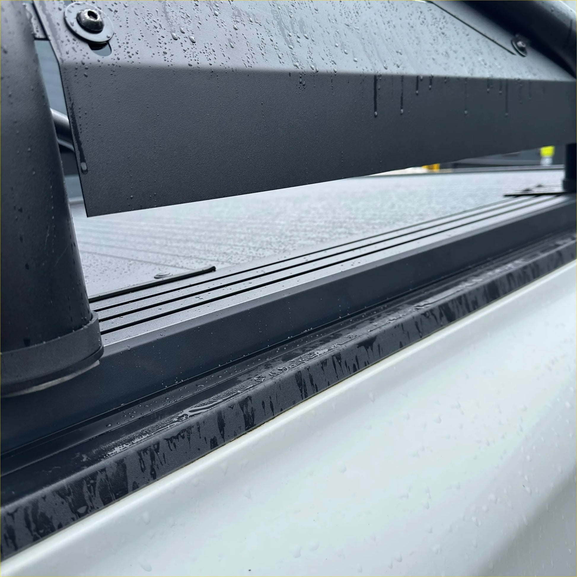 Black metal truck bed liner with textured ridges and water droplets for ford ranger 2022+ roll bar t20 and manual roller shutter