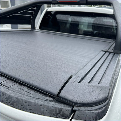 Black, textured, retractable truck bed cover with a sleek, modern design.