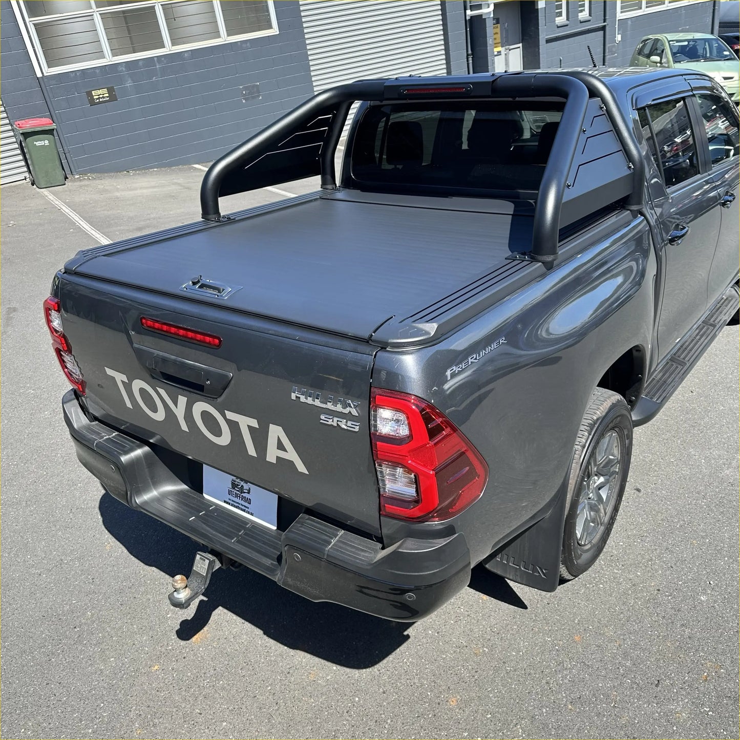 Black roll-up bed liner on the back side of a toyota hilux with roll bar t20 and manual roller shutter 2015-2025