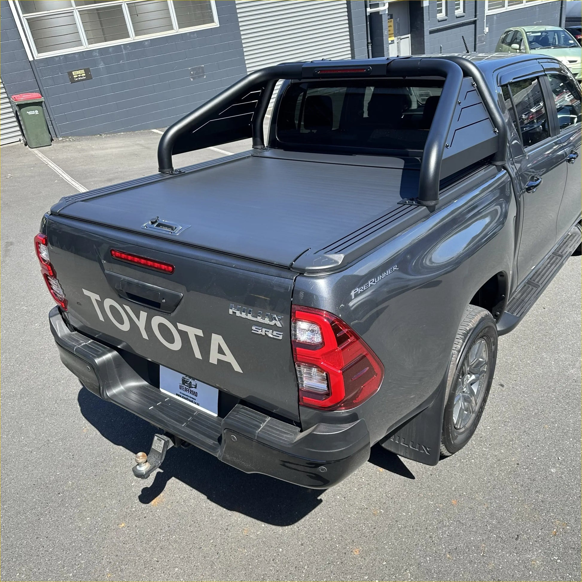 Black roll-up bed liner on the back side of a toyota hilux with roll bar t20 and manual roller shutter 2015-2025