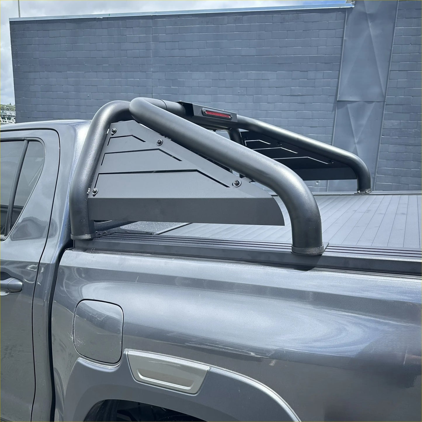 Backside of black metal roll bar t20 with angular cutouts and red taillight for toyota hilux 2015-2025