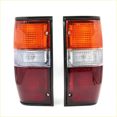 Black-framed rear tail lights with orange clear and red lens sections for mitsubishi triton l200 dodge ram 50