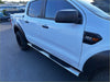 Silver 4 inch oval stainless steel running board with black rubber footpads mounted on white ford ranger double cab side