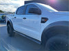 White ford ranger with black running board 4 inch oval tube stainless steel and rugged tires viewed from the side