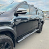 Black stainless steel 4 inch oval tube running board on black toyota hilux with chrome mirrors and black alloy wheels