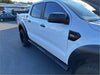 White ford ranger with black stainless steel 4 inch oval tube running board and rugged tires visible from the back