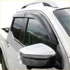 Black plastic window visors installed on a white toyota hilux vigo pickup for weather protection