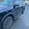 Black ford ranger 2022 double cab with rugged tires and heavy duty steel raptor style side steps shown from the back side