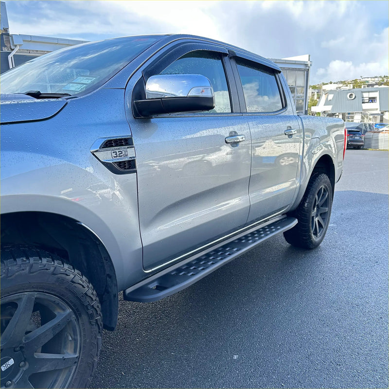 Silver metallic side step raptor style heavy duty steel with textured grip and black edges mounted on ranger px1/2/3 truck
