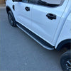 Silver finished textured side step running boards mounted on the side of a white ford ranger 2022 double cab