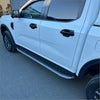 Silver and black textured side step running boards mounted on white ford ranger 2022 double cab truck side view