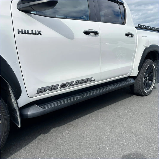 White toyota hilux double cab with black srs cruiser side decals and matching side step running boards oem style 2015-2026