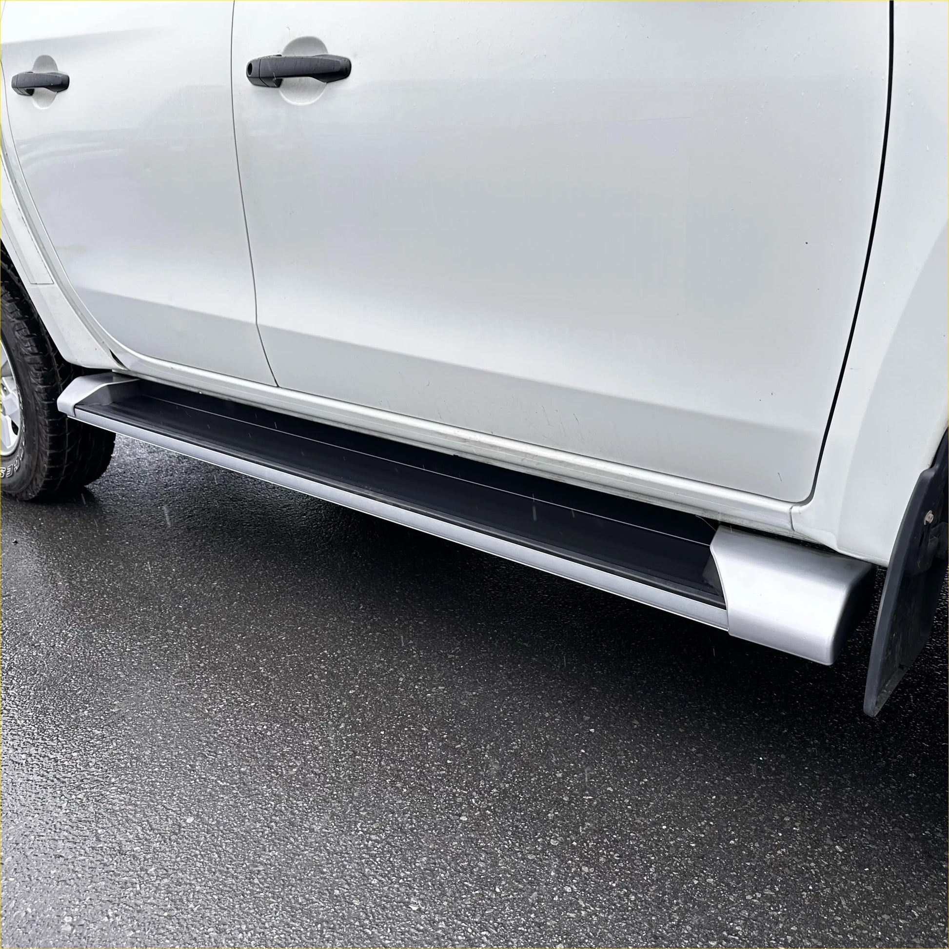 Silver aluminum side step running board with black rubber grip for easy door access on triton 2019-2023 double cab