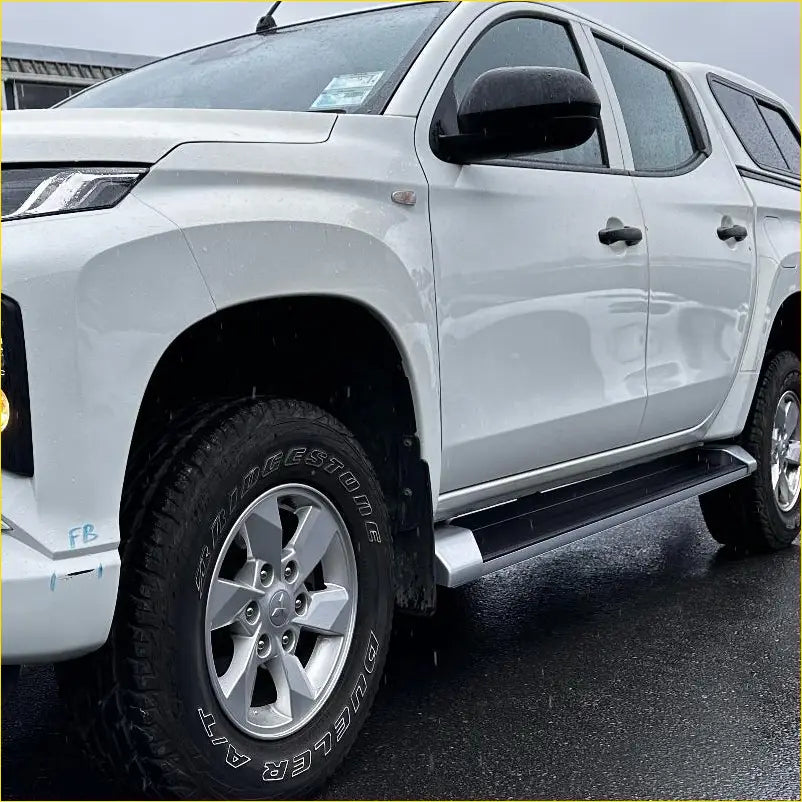 White mitsubishi triton double cab with black OEM style side step running board and silver alloy wheels 2019-2023