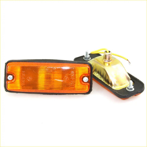 Side turn signal light for mazda bravo b series in orange with black rubber housing and metallic screws visible