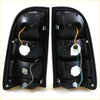 Black plastic smoke led tail light assemblies with wiring and mounts for toyota hilux mk6 sr5 2004-2010 backside view