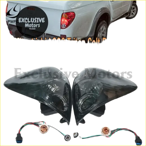 Black smoked tail light assemblies with integrated wiring harnesses for mitsubishi l200 triton colt pickup backside view
