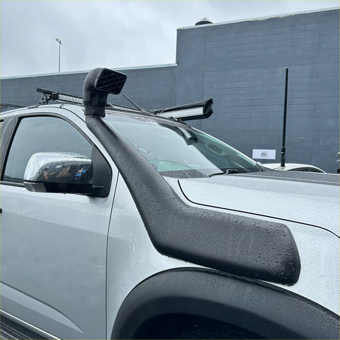 Black rubber snorkel tube mounted on the front of a white holden colorado 2012-2020 pickup truck