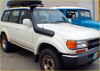White toyota land cruiser 80 series suv with black roof rack and snorkel designed for 1992 to 1998 models