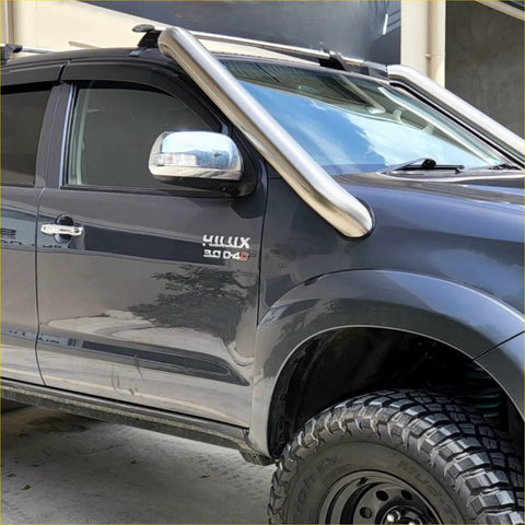 Shiny chrome bull bar mounted on dark gray toyota hilux pickup truck with stainless steel snorkel for 2005-2015 models