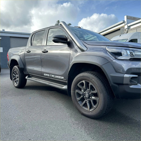 Gray metallic toyota hilux sr5 cruiser pickup with black alloy wheels and stainless steel roof-mounted snorkel for 2015-2025 models