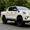 White toyota hilux revo 2015 with black stainless steel snorkel and black off-road tires for rugged use