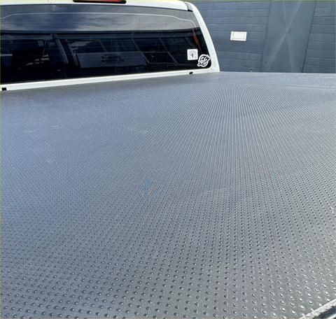 Gray textured truck bed liner with diamond plate pattern on back side of soft tonneau cover for ford ranger 2022+ double cab