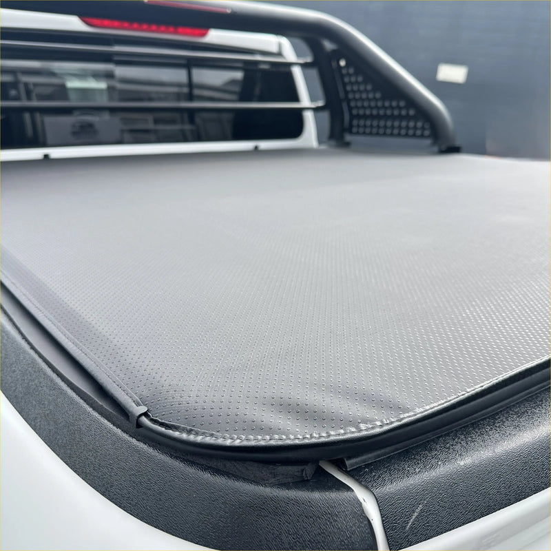 Gray textured soft tonneau cover with black trim and stitched edges for nissan navara np300 2015-2020/navara 2021+ truck bed