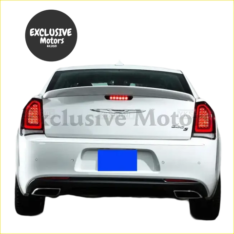Back view of white chrysler 300 s sedan with sleek taillights and sporty rear spoiler lip for 2012-2018 models
