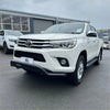 White toyota hilux pickup with chrome accents and black side steps showcasing stainless steel nudge bar black q1
