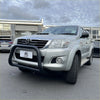 Silver toyota hilux pickup truck with a matte black stainless steel nudge bar front bumper guard 2005-2015 model