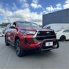 Red toyota hilux pickup with stainless steel nudge bar black front bumper guard and chrome accents 2021-2025 model