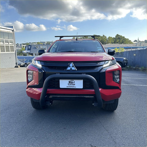 Red mitsubishi triton pickup with matte black stainless steel nudge bar front bumper guard and roof rack
